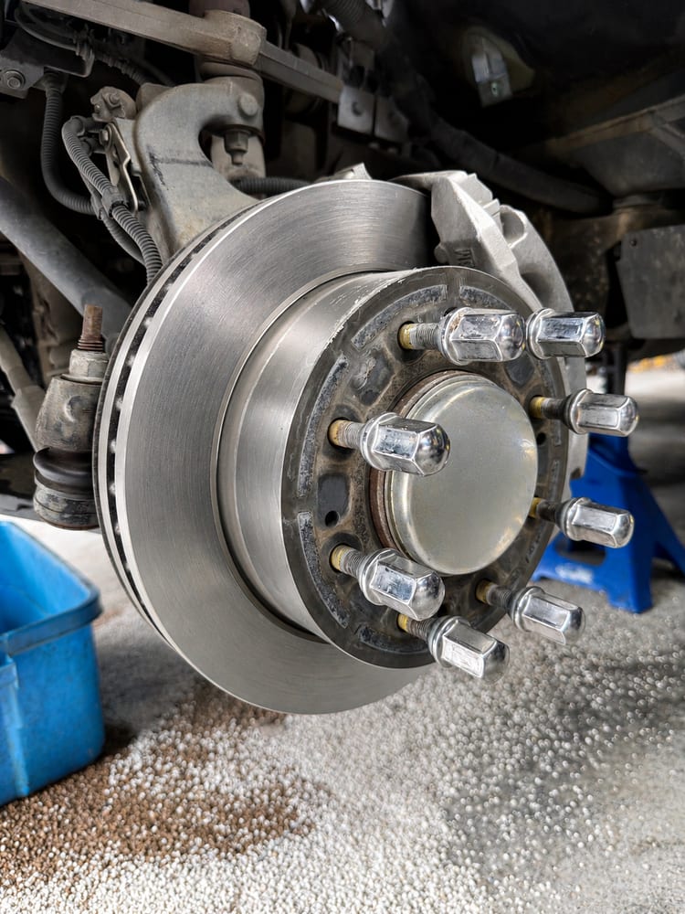 Close-up of a brake rotor and wheel hub during brake service at River City Autohaus